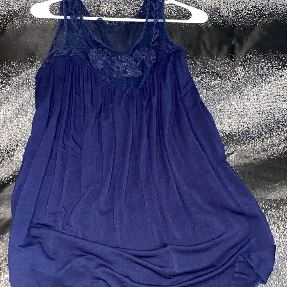 Navy blue torrid top. Runs loose on the belly area